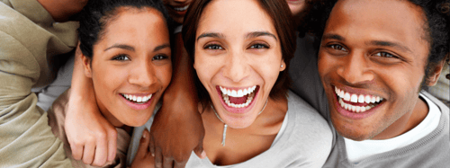 3 friends laughing and looking at the camera