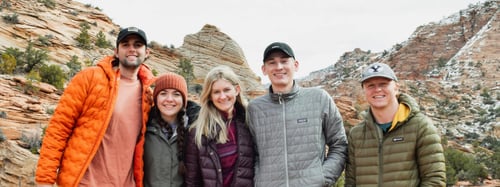 A family standing together in a desert scenery