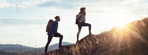 Couple hiking up a mountain together