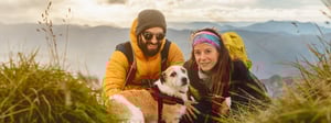 Couple adventuring with their dog and hiking gear