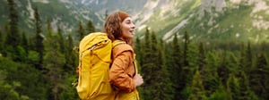 Woman hiking with her backpack in a beautiful mountain range