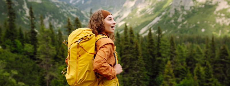 Woman hiking with her backpack in a beautiful mountain range