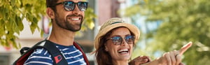 Traveler couple smiling and pointing into the distance