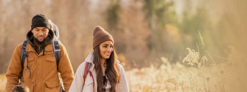 Couple walking through field
