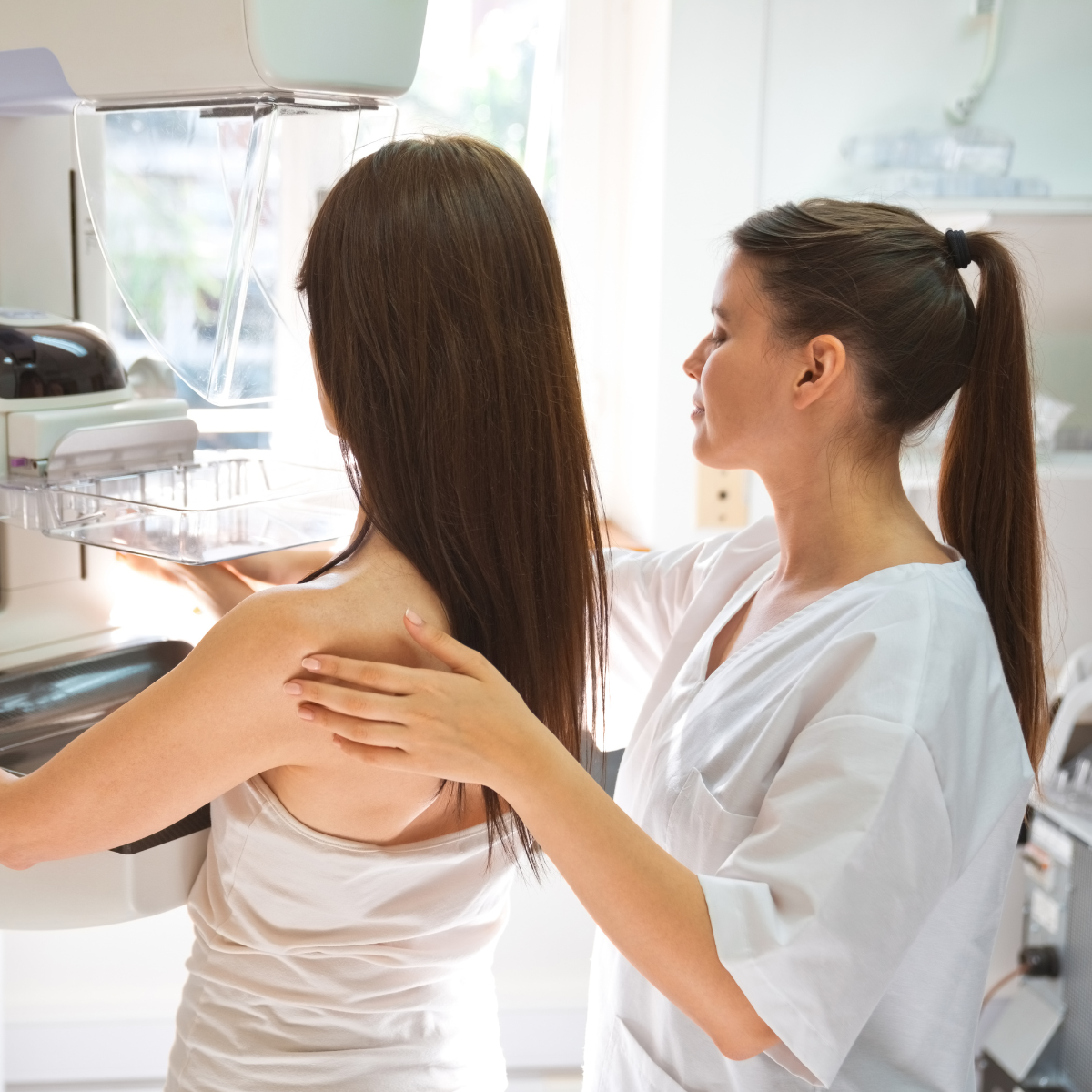 Mammo tech working with a patient