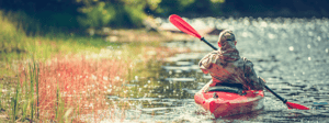 Man kayaking on a lake