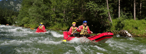 People white water rafting down a river