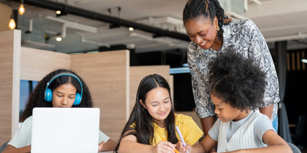 Teacher assisting students with work