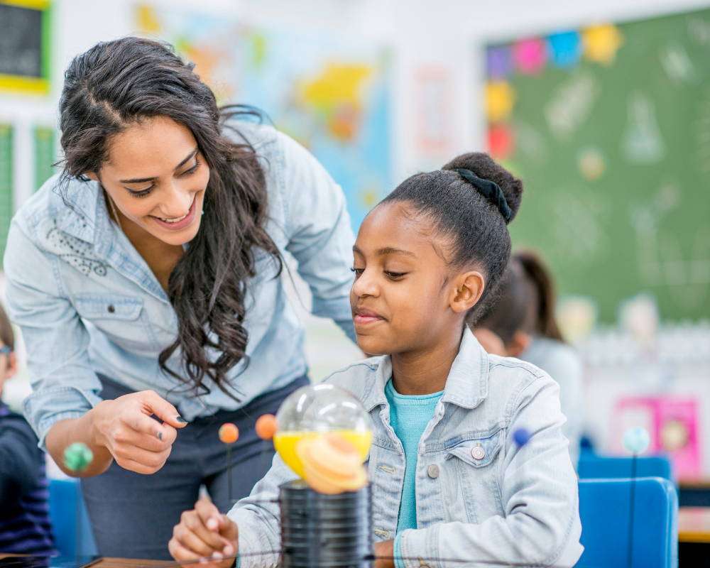 Teacher working with a student on a project