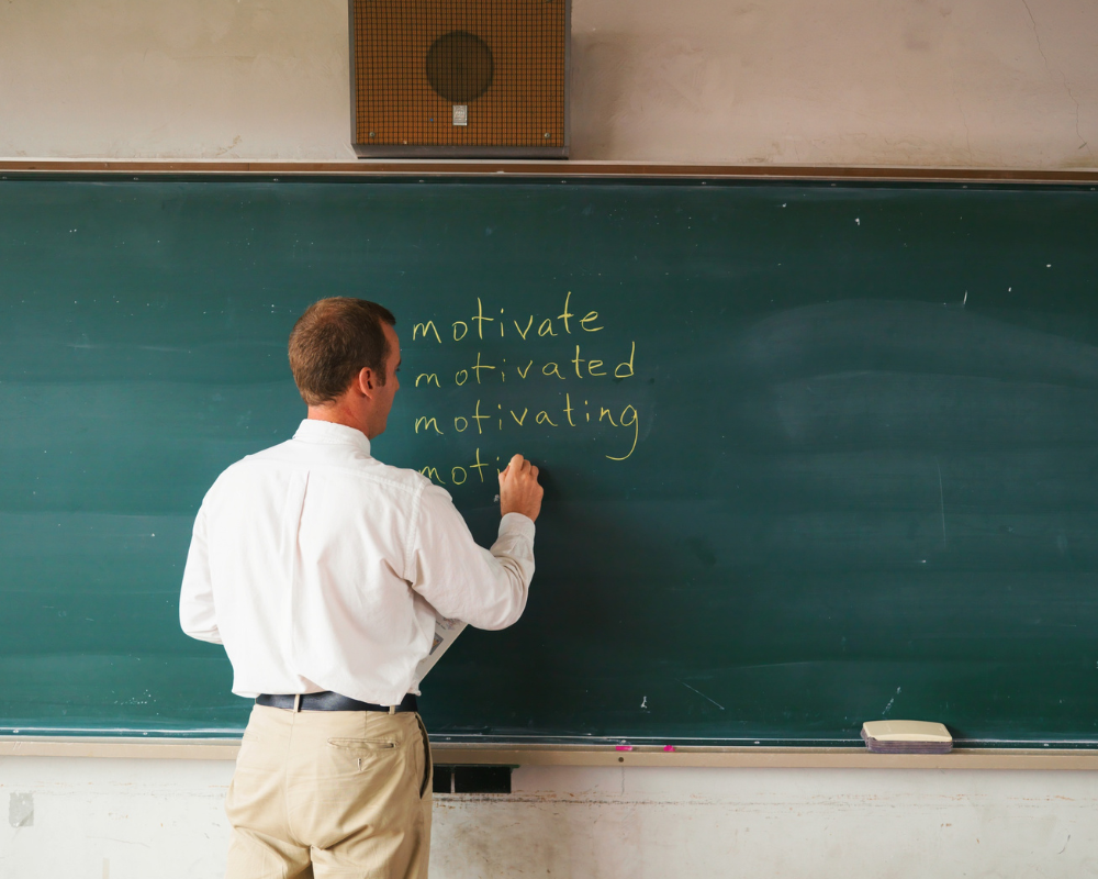 Teacher writing on a chalkboard