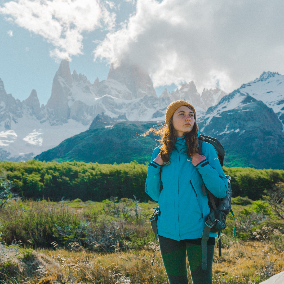 Woman backpacking through a mountain range