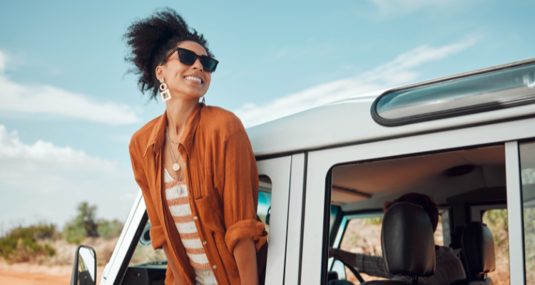 Woman leaning out of a car window and smiling