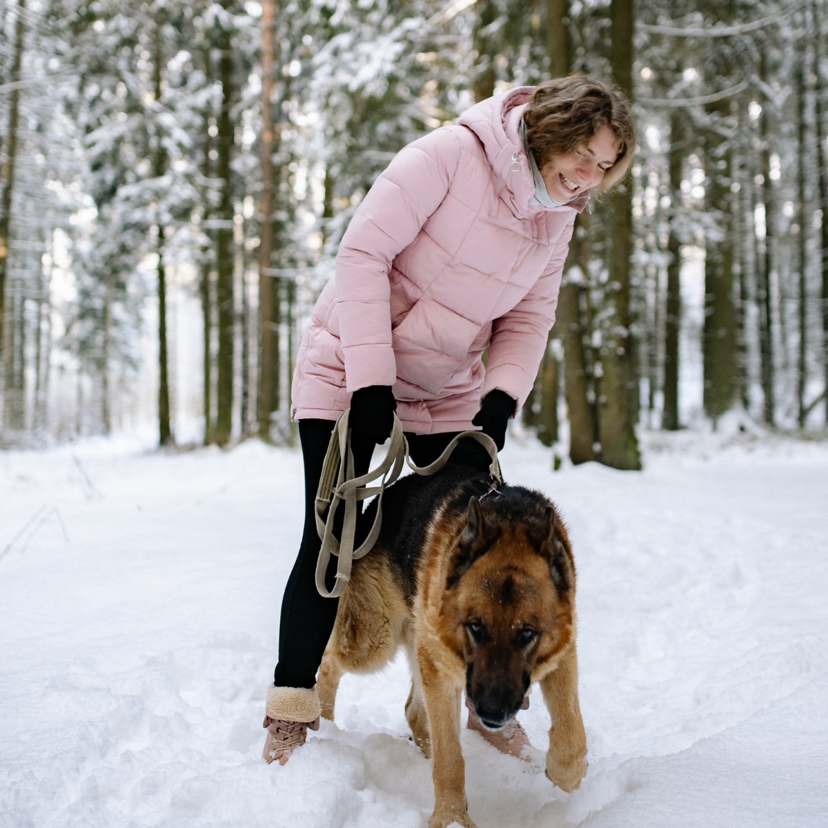 Woman walking her dog in the snow