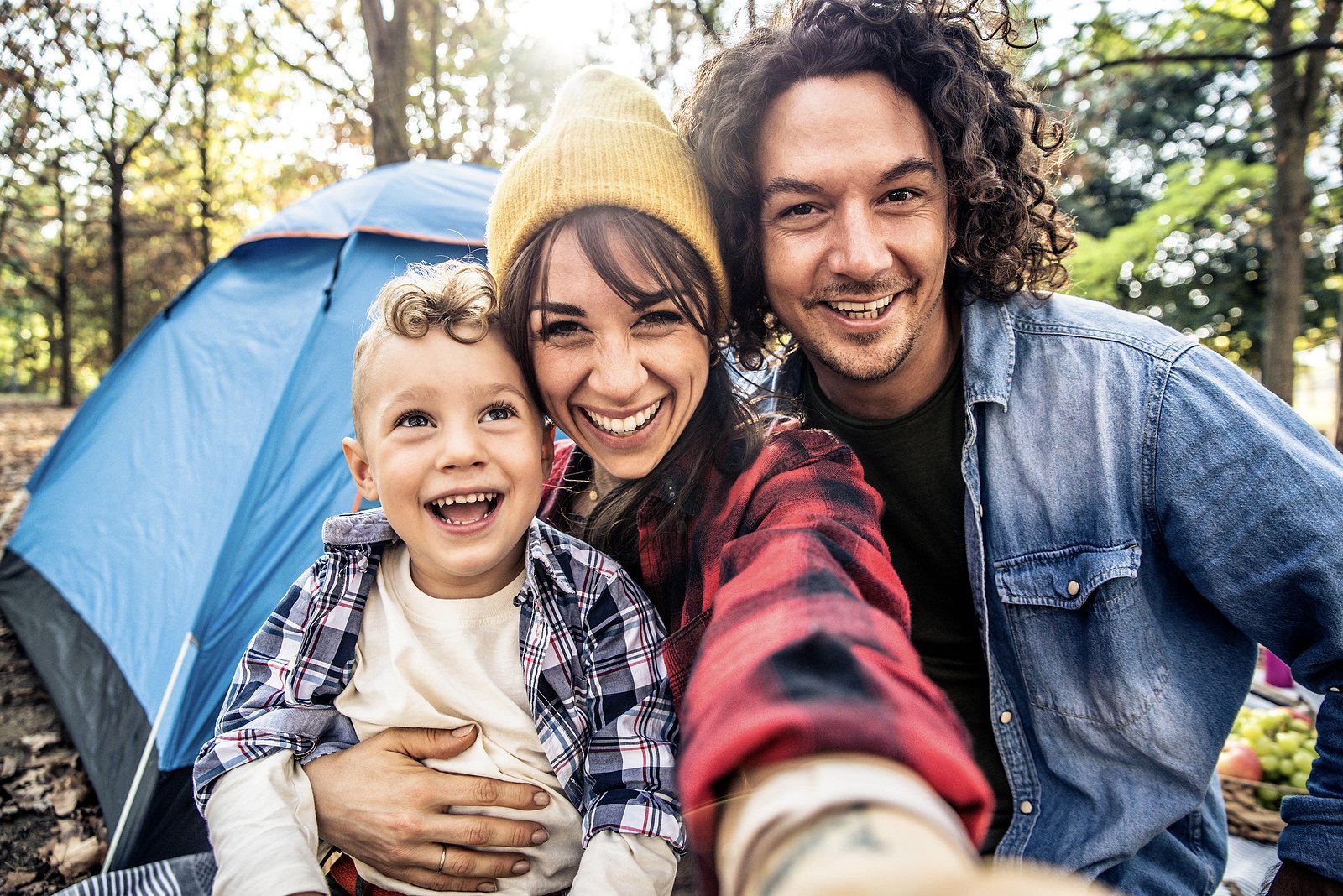 Happy family of 3 camping