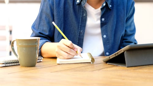 Person writing in a notebook
