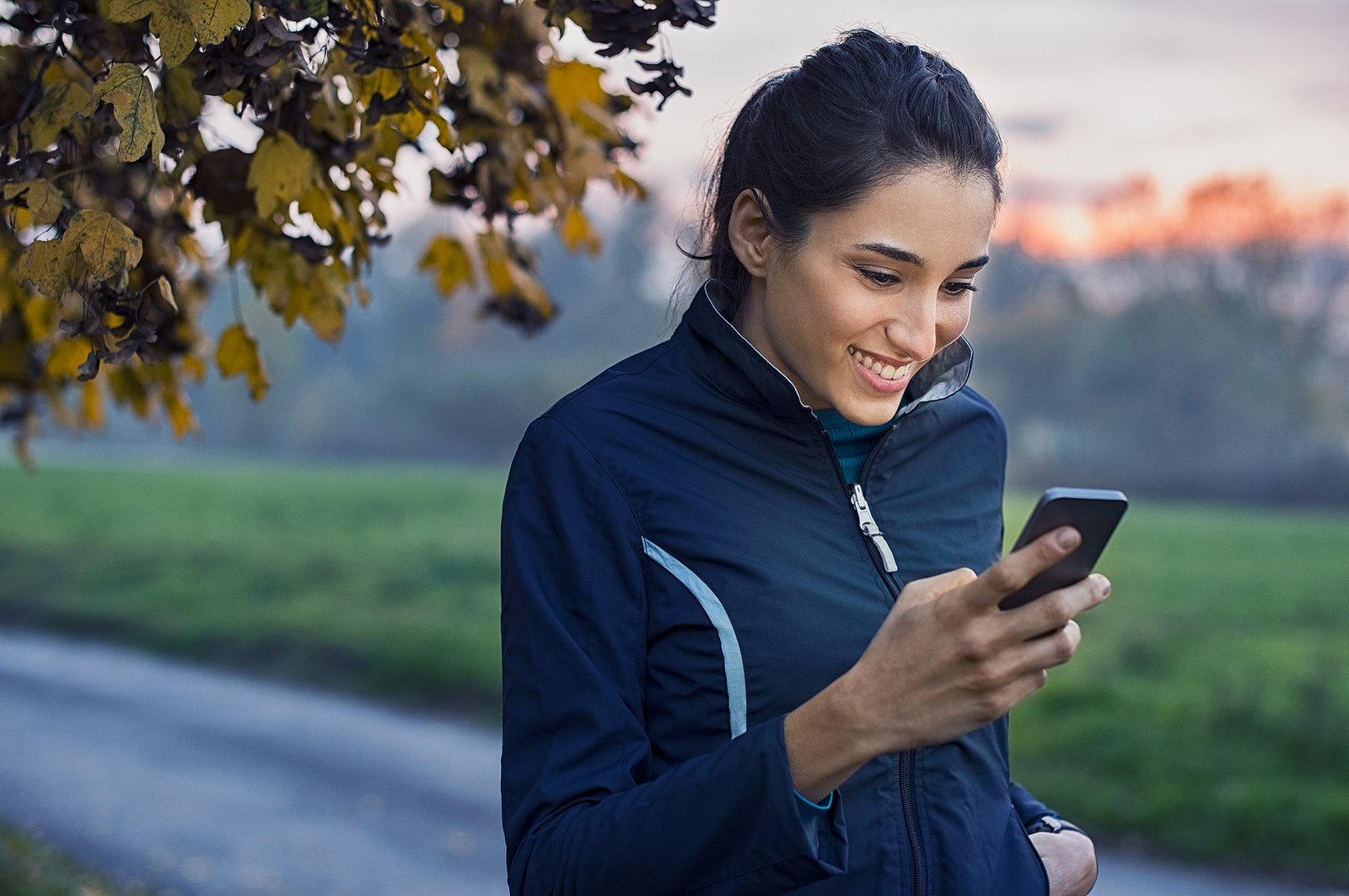 Woman looking at her phone smiling