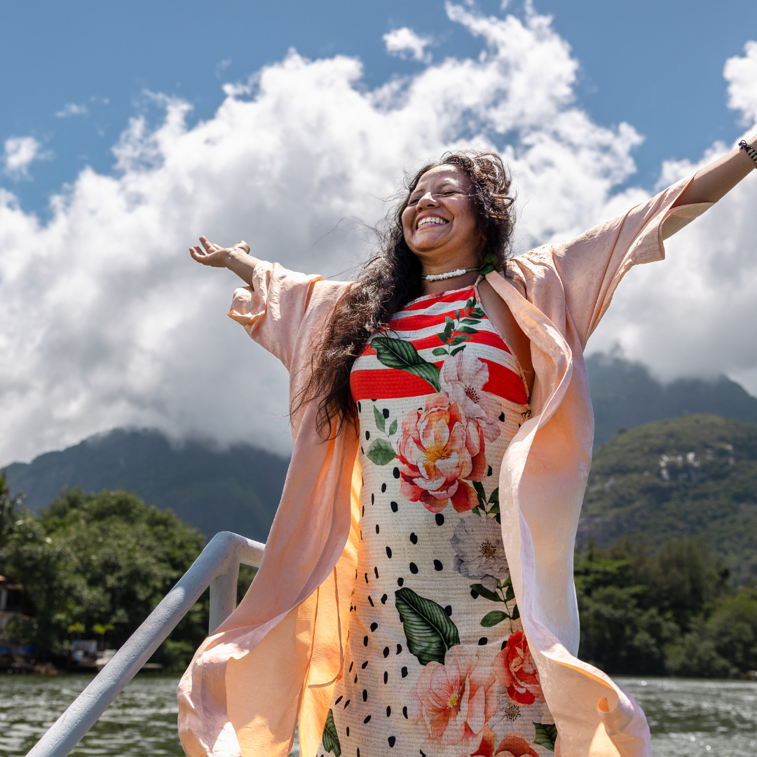woman with her hands in the air smiling