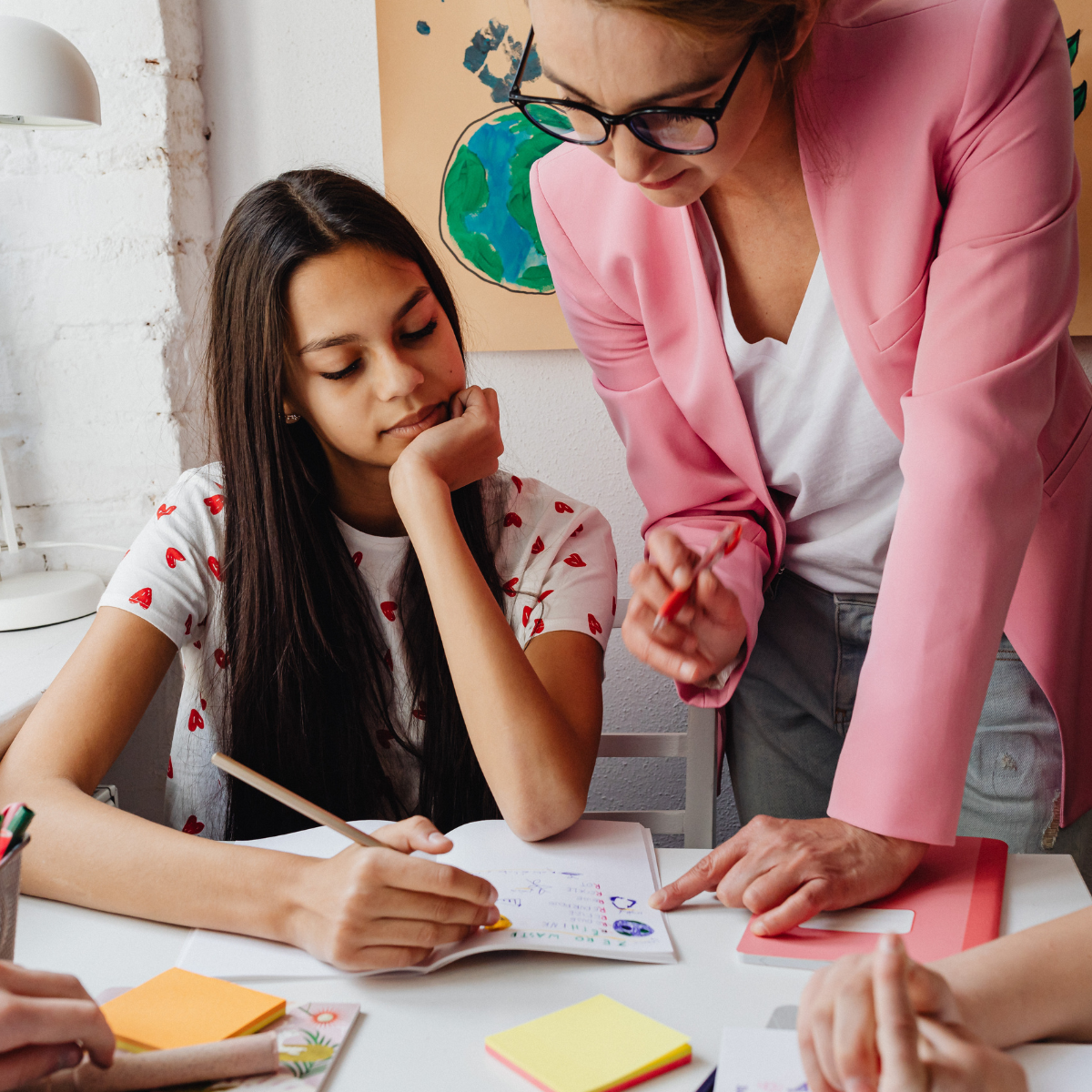 teacher helping a student with work