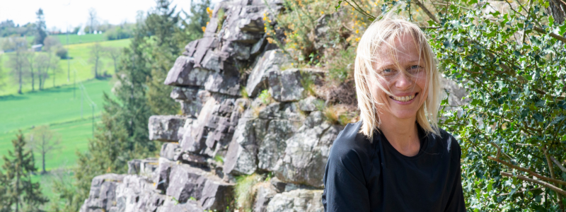 Woman smiling with rocks in the background