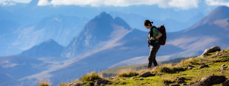 Woman hiking through a mountain range