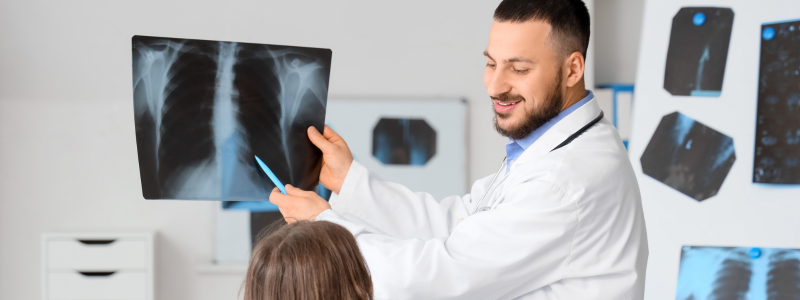 Rad tech showing a patient an x-ray 