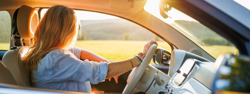 Woman driving in a car looking out the window