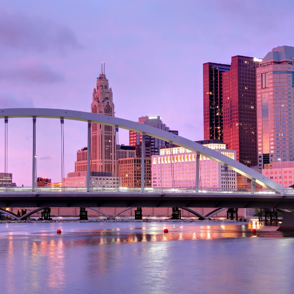 City view with bridge and a sunset in the background