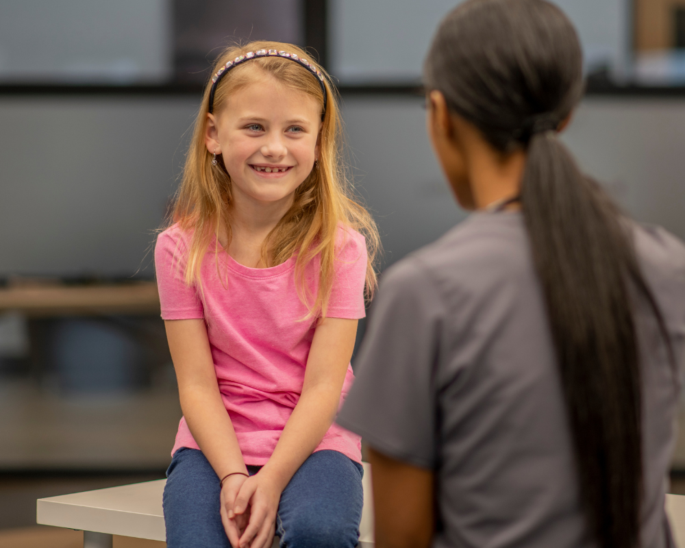 School nurse speaking with a smiling student