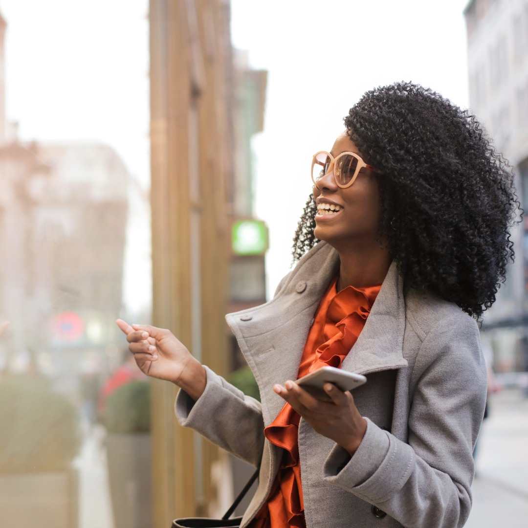 Woman standing in a city smiling