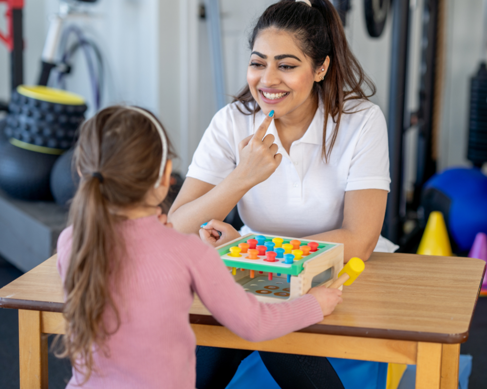 Speech language pathologist helping a student mouth words